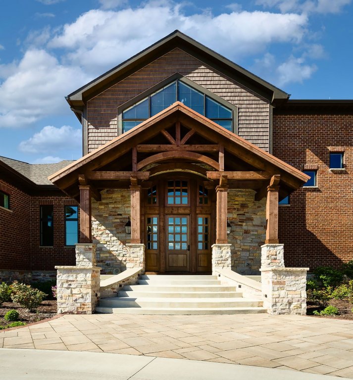 residential exterior with custom wood door, beams, columns entrance 
